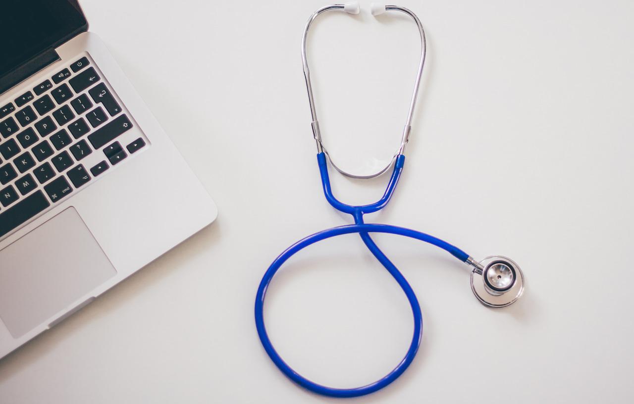 Stethoscope and laptop on a desk